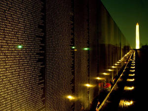 A Veteran Pays His Respects At The Vietnam Veterans Memorial During A Memorial Day Ceremony. Wallpaper