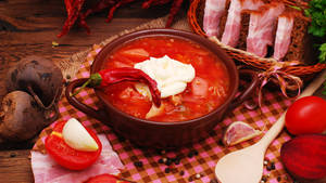 A Vibrant Bowl Of Chili Tomato Borscht. Wallpaper