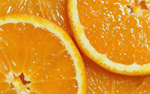 A Vibrant Section Of Juicy Juicy Orange Fruit. Wallpaper