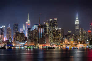 A View Of New York City's Skyline Emerging Through The Morning Fog Wallpaper