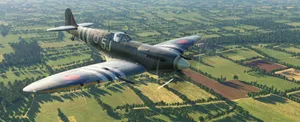 A Vintage Fighter Plane Flying Over A Field Wallpaper