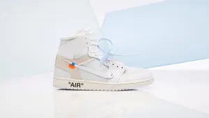 A White And Blue Nike Jordan 1 High Is On A White Surface Wallpaper