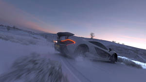 A White Car Driving Down A Snowy Road Wallpaper