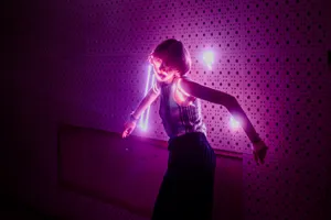 A Woman Dancing In A Vibrant Purple Aesthetic Wallpaper