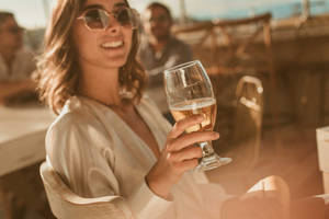 A Woman Enjoying A Cold Beer On A Hot Day Wallpaper