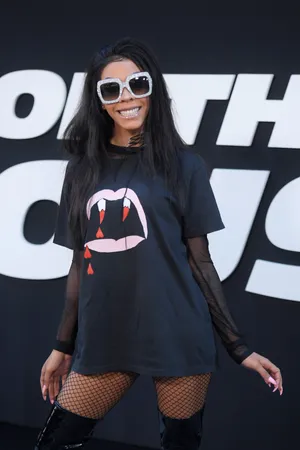 A Woman In A Black Shirt And Thigh High Boots Poses For A Photo Wallpaper