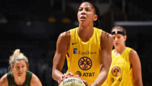 A Woman In Yellow Uniform Is Holding A Basketball Wallpaper