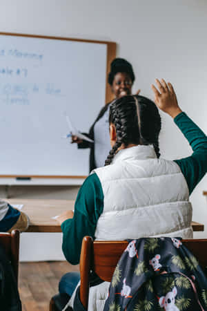 A Woman Is Raising Her Hand In Front Of A Whiteboard Wallpaper