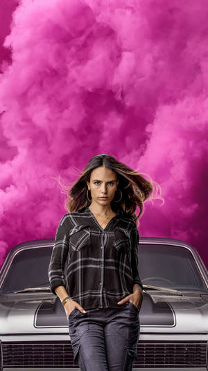 A Woman Standing Next To A Car With Pink Clouds Wallpaper