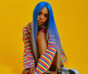 A Woman With Blue Hair Sitting On A Yellow Background Wallpaper