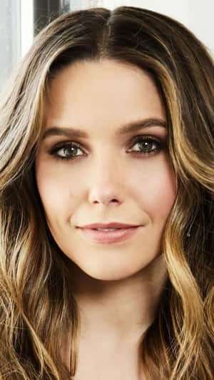 A Woman With Long Brown Hair Posing For A Photo Wallpaper