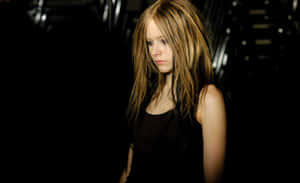 A Woman With Long Hair Standing In A Dark Room Wallpaper