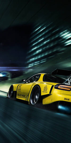 A Yellow Sports Car Driving Down A Dark Street Wallpaper