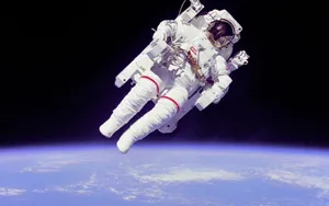 A Young Astronaut Explores The Vastness Of Space Wallpaper