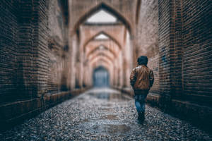 A Young Boy Braving The Rain On A Rainy Day Wallpaper