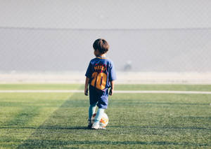 A Young Hopeful Looks Forward To One Day Wearing Lionel Messi's Jersey. Wallpaper