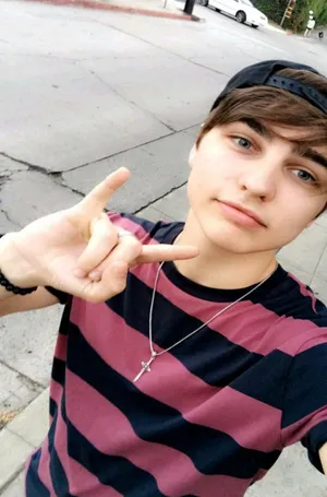 A Young Man Is Making A Peace Sign Wallpaper