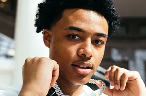 A Young Man With A Necklace On His Neck Wallpaper