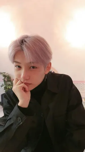 A Young Man With Pink Hair Posing For A Picture Wallpaper