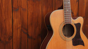 Acoustic Guitar In Vibrant Brown Shade Wallpaper