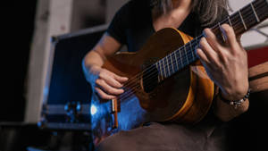 Acoustic Guitar On A Lap Wallpaper