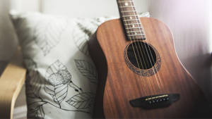 Acoustic Guitar With Pillow Wallpaper