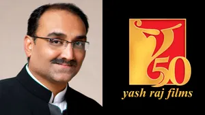 Aditya Chopra Poses With The Yrf Logo Wallpaper