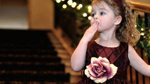 Adorable Baby Girl Playing Peek-a-boo With Pink Blanket Wallpaper