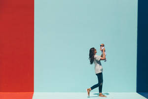 Adorable Baby Girl Playing With Colorful Toys Wallpaper