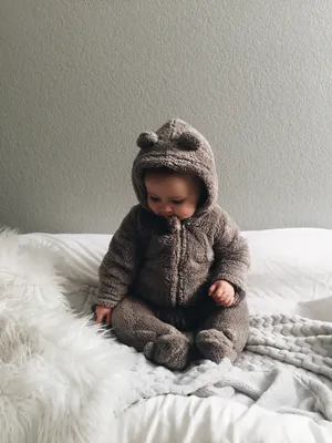 Adorable Baby Smiling With Curiosity Wallpaper