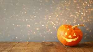 Adorable Halloween Pumpkin On Autumn Leaves Wallpaper