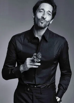 Adrien Brody Holding A Flower Wallpaper