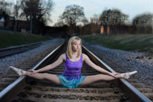 Adventurous Traveller Contemplating At Train Tracks Wallpaper