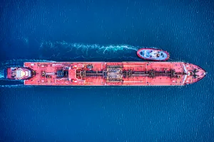 Aerial Shot Of A Red Cargo Ship At Sea Wallpaper