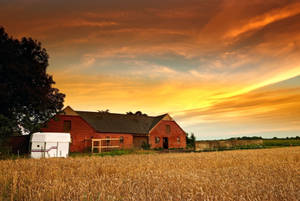 Aerial View Of A Pastoral Farm Near The Countryside Wallpaper