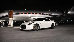 Aerial View Of Luxury Car And Jet Race Wallpaper