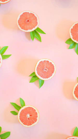 Aesthetic Pink Grapefruit With Leaves Wallpaper