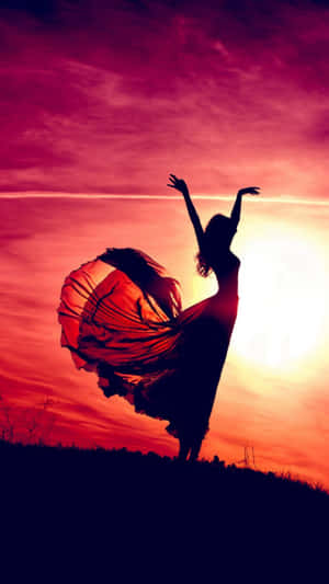 Aesthetic Sunset Iphone With Silhouette Of Woman Wearing A Dress Wallpaper