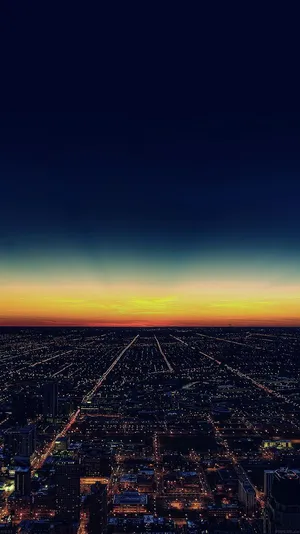 Aesthetic Sunset Iphone With Skyscrapers And City Lights Wallpaper