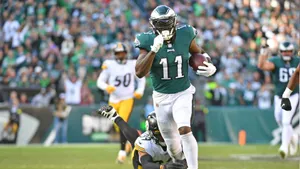 Aj Brown Running From An Opponent Wallpaper