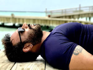 Ajay Devgn At Beach Resort Wallpaper