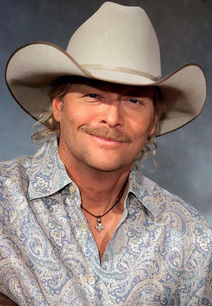 Alan Jackson Portrait Against Gray Limewash Wallpaper