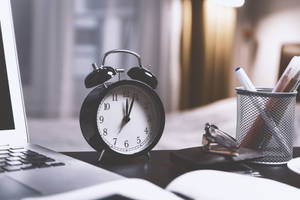 Alarm Clock On Desk Wallpaper