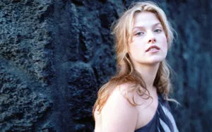 Ali Larter Posing Against A Rock Wallpaper