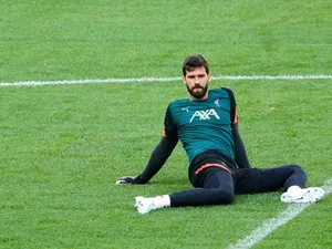 Alisson Becker Sitting On The Field Wallpaper