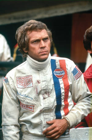 American Actor Steve Mcqueen In Racing Scene Wallpaper