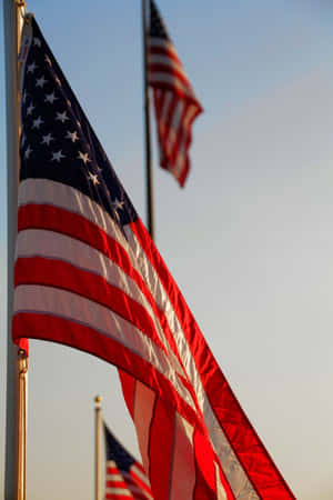American Flags Wavingat Dusk Wallpaper
