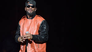 American Singer R Kelly In Orange Jacket Wallpaper