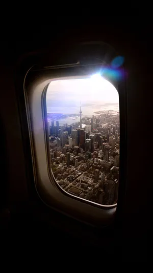 An Aerial City View From A Plane Window Wallpaper