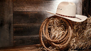 An American Cowboy Riding His Horse In The Desert Wallpaper